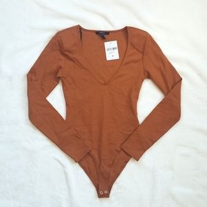 NWT burnt orange bodysuit. Size small.